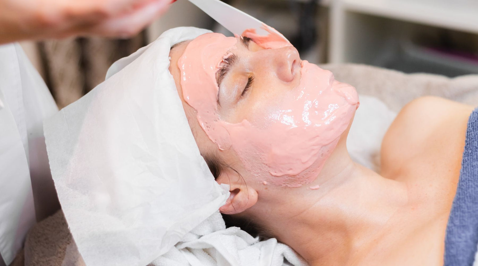 Woman with rose jelly mask at beauty spa