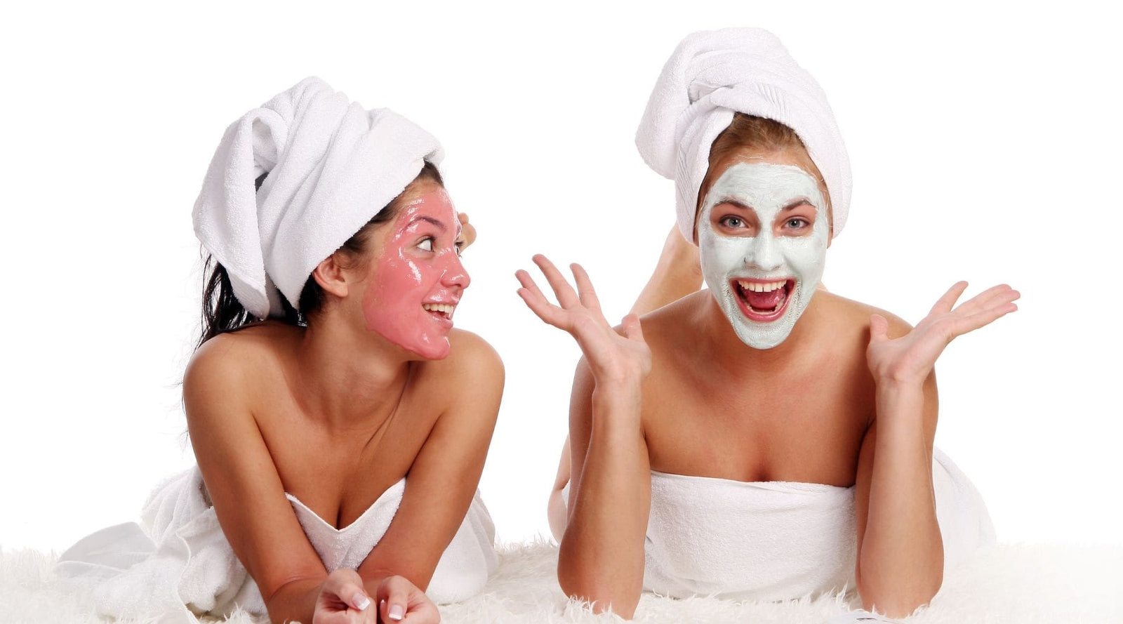 One woman using clay mask and another one using rose petals jelly mask
