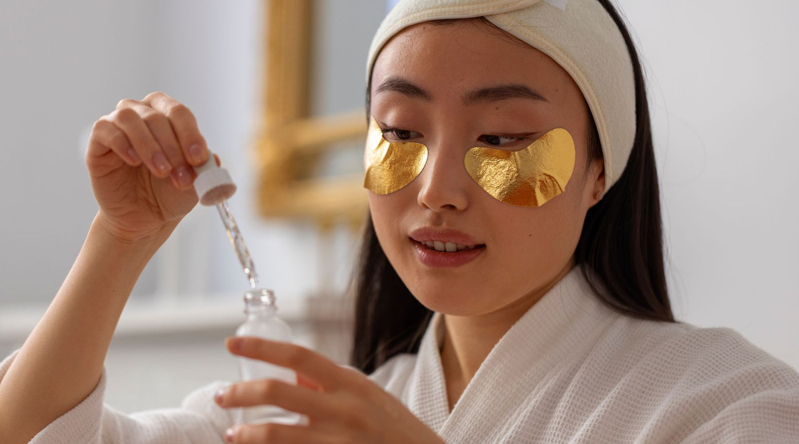 Woman using gold jelly mask 
